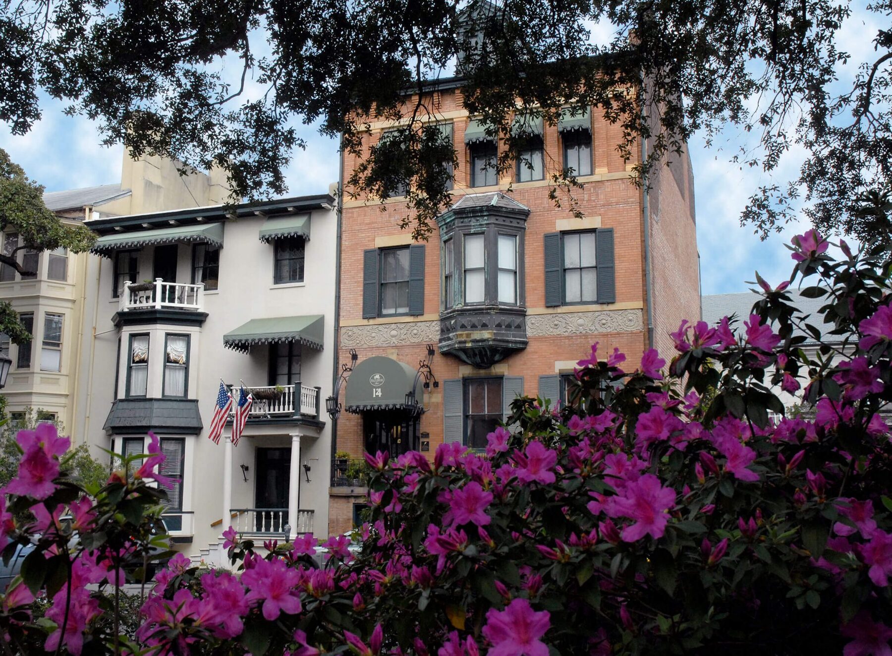 Foley House Inn exterior framed by blooming azaleas